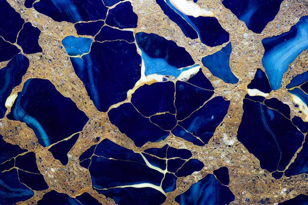 Ultramarine blue and gold marble abstract background. Decorative acrylic paint pouring rock marble texture. Horizontal Ultramarine blue and gold wavy abstract pattern.