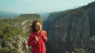 Kırmızı ceketli turist kadın yürüyüşçünün portresi uçurumun kenarında duruyormuş. Amazing Tazi Canyon, Bilgelik Vadisi, Manavgat, Antalya, Türkiye. Tazı Kanyonu