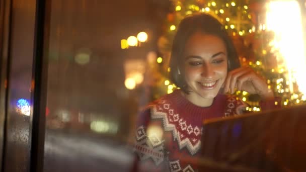 Festive Weared Woman Sits Decorated Cafe Close Window Christmas Eve — Stockvideo