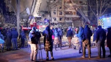 12-storey residential building was destroyed by massive Russian missile attack, work of rescuers and volunteers to clear rubble and search for wounded, Dnipro, Ukraine - 14 Jan 2023. by the evening of