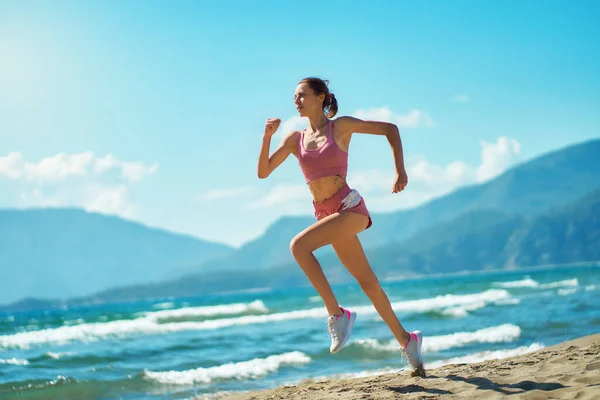 Focused Strong Young Woman Running Sunny Beach Seaside Sprinting Fast Stockfoto
