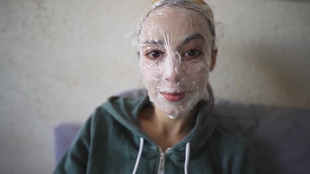 Close Portrait Young Caucasian Woman Handmade Cosmetic Mask Face Sits — Video