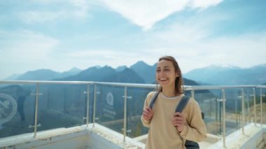 treking camera shot rear view traveler freedom woman with open arms laughing and enjoying mountains view, summer journey vacation