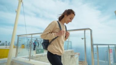 treking camera shot rear view traveler freedom woman with open arms laughing and enjoying mountains view, summer journey vacation