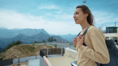 Tourist traveler standing on viewing platform agaist blue background valley landscape view mockup for text. hipster young girl in casual clothes enjoying a view from mountain to sea and Antalya city