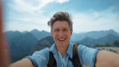 POV Traveler man making video selfie on camera for travel blogg, or making video call, standing in front of mountains. Tunektepe Teleferik, Antalya