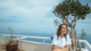 Tourist traveler standing on viewing platform agaist blue background valley landscape view mockup for text. hipster young girl in casual clothes enjoying a view from mountain to sea and Antalya city