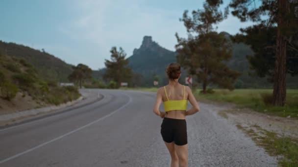 Slow Motion Oppfølger Shot Young Athlete Woman Running Fast Road – stockvideo