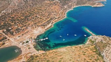 Yukarıdan bakıldığında, şeffaf ve turkuaz deniz manzaralı birkaç tekne ve yatla. Akdeniz kıyıları, Knidos Antik kenti, Datca, Türkiye. Yaz tatili ve deniz kenarına seyahat