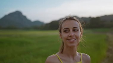 Genç Atlet Kadın 'ın yavaş çekim portresi Yeşil Tarlalar boyunca koştuktan sonra güzel yeşil kırsal manzaranın tadını çıkarıyor..
