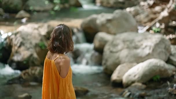 Young Woman Hiker Orange Sundress Walks Mountain River Boulders Looking — Stock Video