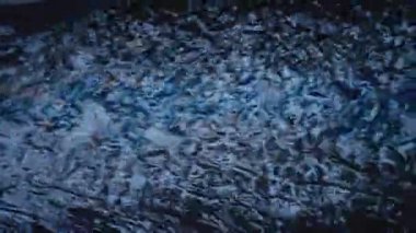 Sonbahar yağmurundan sonra şehir yolunda hızlı yağmur suyu akıntısı. Mavi suya düşmüş sarı yaprak. Mevsimsel yağmurlu günler. Şehir kanalizasyonu. şehir altyapısı, yavaş çekim üst görünümü