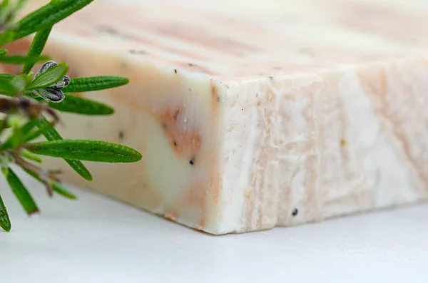 Bar of handmade soap with rosemary, textured pink marbled soap
