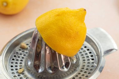 Bir el sıkacağının üzerindeki yarım limon resmini kapat