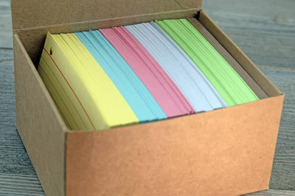 Close up image of brown box with coloured blank index cards Copy space