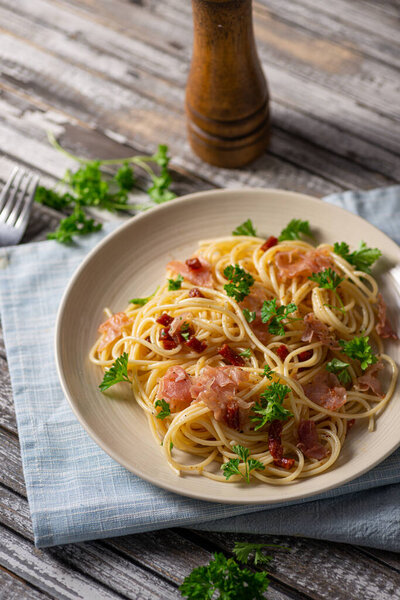 Delicious pasta with garlic, ham and parmesan