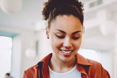 Afro-Amerikalı kadın blogcu mobil iletişim uygulaması üzerinden sohbetten zevk alıyor, pozitif hipster kız cep telefonuyla internete baktığı için komik metinlerle posta yazıyor.