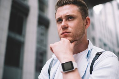 Sıradan bir milenyumun altında akıllı saat takan ve düşüncelere dalmış bir şekilde çene çalan bir adamın şehir geçmişine dalgın dalgın dalgın bakışıyla