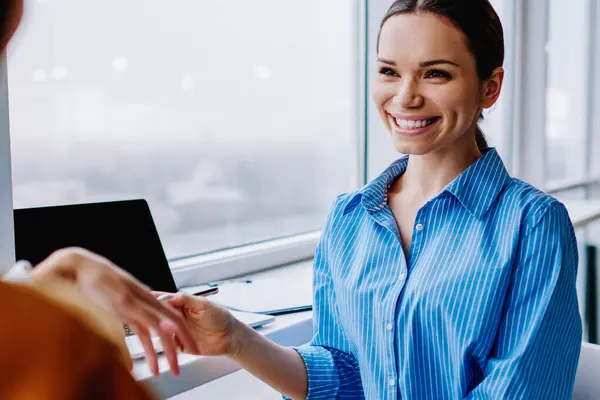 Cheerful caucasian woman in formal wear having conversation on meeting interview satisfied with conversation, cropped image of happy female employee discussing planning for work in modern office