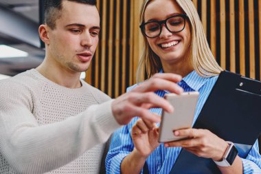 Modern sınıfta akıllı telefon başarılı öğretmeninde komik tebligat gösteren genç adam. Sosyal ağlarda haberlerin paylaşımında sosyal ağlarda tartışan pozitif öğrenciler.