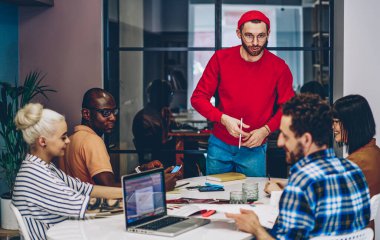 Birlikte iş planlamayı tartışan çok ırklı erkek ve kadın meslektaşlardan oluşan bir ekip, ciddi koçlar, çalışma odasındaki çeşitli öğrencilerle ders ve atölye çalışmaları sırasında sorular soruyorlar.