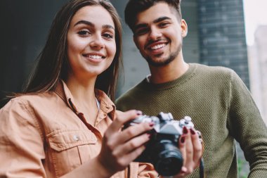 Şehirde vintage kamera kullanarak hobi serbest zaman harcama neşeli erkek ve kadın arkadaşlar Portresi, hipster çift kamera ve gülümseme bakarak görüntü çekmek için ekipman ile birlikte dinlenme