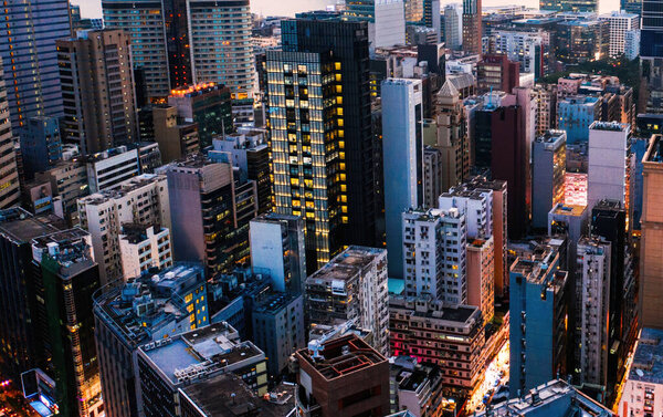 Aerial scenery panoramic view of Hong Kong modern skyscrapers district. Urban drone view with corporate business and financial enterprise buildings. Metropolitan city infrastructure in twilight time