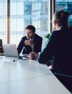 Deneyimli ekonomistler ofiste toplantı sırasında finansal web sitesinde dizüstü bilgisayarla bilgi kontrol ediyorlar. Beyin fırtınası yapan ve fikir paylaşan bir grup profesyonel. Başarılı takım çalışması kavramı