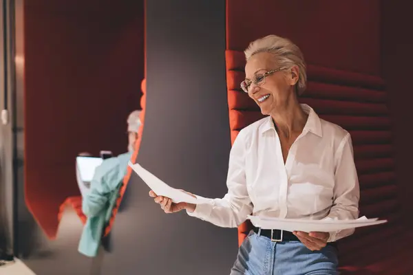 Radiant Senior Caucasian Businesswoman White Blouse Reviewing Papers Content Smile Royalty Free Stock Photos