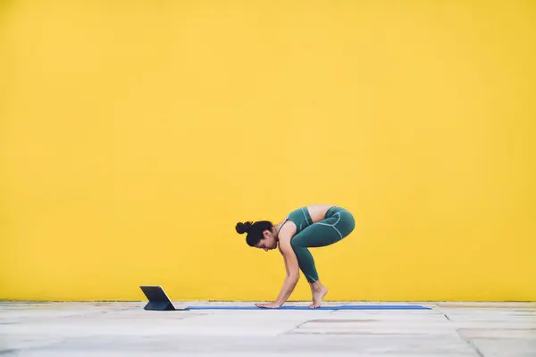 Side View Adult Slim Female Doing Preparation Pose Practicing Yoga Стокове Зображення