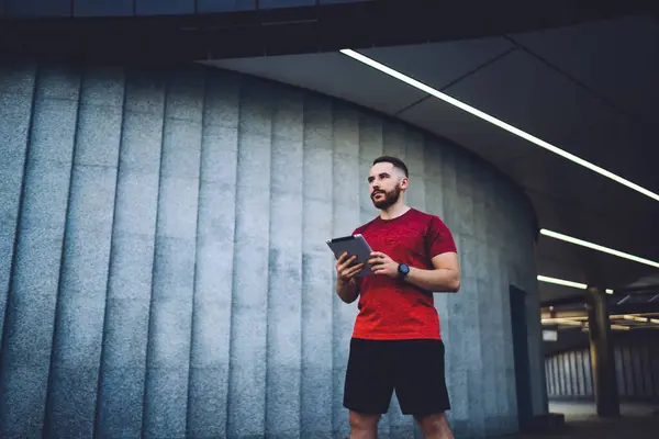 Bearded Male Trainer Looking Away Chilling Morning Workout While Standing Stock Photo
