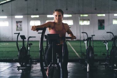 Egzersiz yapan kararlı bir kadının portresi yoğun kardiyo eğitimi sırasında kendini adama, modern spor salonunda zayıflama - sağlıklı yaşam tarzını ve canlılığını koruma