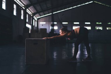 Aktif kıyafet eğitimi alan beyaz bir kadın spor salonunda kutu ekipmanlarıyla mükemmel vücut şeklini koruyor kaslarını esneten esnek bir kadın antrenmanda iyi sonuçlar elde ediyor vücut geliştirme ve kardiyo çalışması.