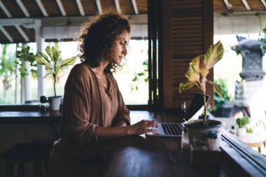 Uzak görev için içerik bilgilerine sahip modern netbook üzerinden 4G 'ye bağlanan genç serbest metin yazarı, metin ve grafik tasarımı yaratan Kafkas dijital göçebe