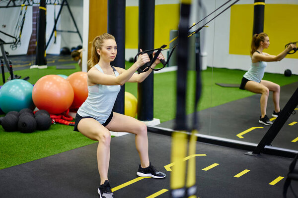 Full Body Focused Sportive Woman Activewear Doing Squats Trx Straps Royalty Free Stock Images