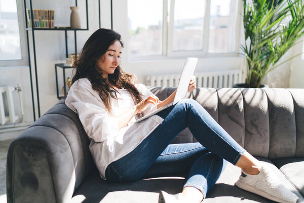 Side View Female Sitting Sofa Using Netbook While Working Remotely Royalty Free Stock Photos