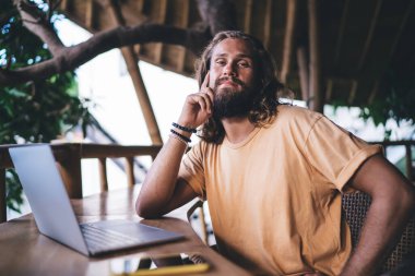 Terasta dizüstü bilgisayar üzerinde uzaktan çalışma için poz veren yetenekli serbest yazar portresi, netbook bilgisayarlı Kafkas bilişim uzmanı dijital göçebe yaşam tarzını koruyor