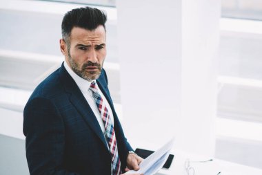 Üstten görünüm muhasebe raporları elinde tutan formal giyim giymiş başarılı emin girişimci 50 yaşında. Ciddi olgun gurur CEO'su kağıt belgeleri bankacılığı ile portresi
