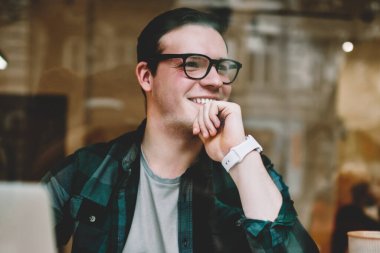 İyi bir ruh hali içinde müreffeh erkek freelancer kafe, dizüstü bilgisayar ile oturup proje tamamlanması ile web sayfası yayın için makale harika fikir hakkında mutlu oluşturma hipster adam gülümseyen memnun