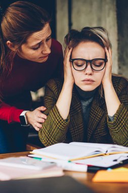 Yardım bakım kadın öğretmen öğrenci sınavına hazırlanması için yorgun. En iyi arkadaşım depresif ve demotivational hippi kız hangi öğrenme destek eğitim materyali ders kitabından karıştı