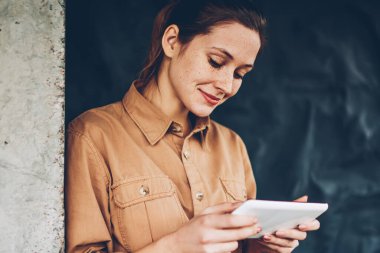 Pozitif kadın blogger ilginç eğitsel online web sitesi üzerinden yüksek hızlı izlemek için dijital tablet Internet bağlı. Hipster öğrenci sosyal ağlar modern dokunmatik yüzey üzerinde iyi haber okuma