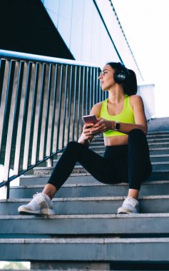 Şehir merdivenlerinde dinlenen elektronik teknoloji dalında düşünceli bir bayan koşucu ve ABT tatbikatları hakkında kafa yoran, cep telefonu dinleme yeteneği olan, yaşam gücü hakkında kitap okuyan bir kız.