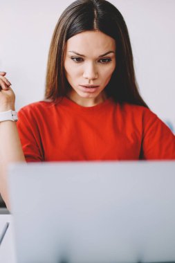 Yoğunlaştırılmış geliştirici, internet alanı için yeni içerik web sitesi için program kodu oluşturma üzerine kafa yoruyor, ciddi kadın serbest çalışan iş ve dizüstü bilgisayarla web sayfasından bilgi almakta zorlanıyor