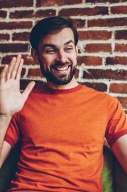 Video aramasý sýrasýnda video arkadaşıyla konuşuyor ve ön kamera ile 4 g tablet üzerinde el sallayarak mutlu sakallı blogger Internet. Dokunmatik yüzey üzerinde yüksek hızlı wifi bağlantısı üzerinden iletişim olumlu genç adam