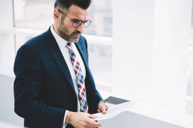 Kendine güvenen düşünceli proude CEO'su resmi aşınmaya muhasebe bilgi veri çözümleme raporları tanding ofisinde. Olgun girişimci 50 yaşında düşünme metin belgeleri bankacılık üzerinde durulması