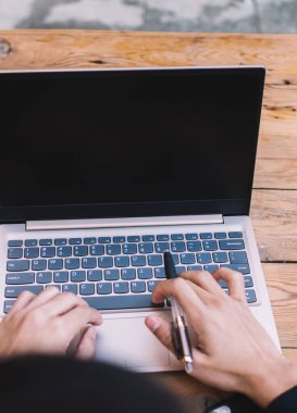 Laptop bilgisayarında çalışan erkeklerin kablosuz internet bağlantısını uzaktan kontrol etmesi, iş adamlarının kafeteryadaki online proje için uzak mesafe iş kullanımı teknolojisinin üst görünümü
