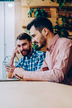 Öğrenme yolu ile netbook için online araştırma yapma hipster adam yetenekli erkek programcılar, teknolojisini kullanarak fikirleri tartışmak proje üzerinde işbirliği iletişim arkadaşıyla alan coworking içinde