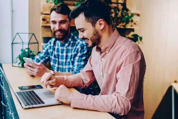 Öğrenme ve ödev college Kampüsü, içinde birlikte müreffeh erkek programları ile araçlar coworking'da oturan iş fikirleri tartışmak için modern dijital cihazlar kullanılarak hipster çocuklar gülümseyen