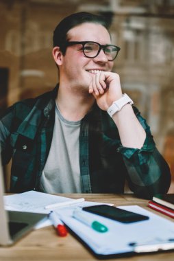 İyi bir ruh hali içinde müreffeh erkek freelancer kafe, dizüstü bilgisayar ile oturup proje tamamlanması ile web sayfası yayın için makale harika fikir hakkında mutlu oluşturma hipster adam gülümseyen memnun