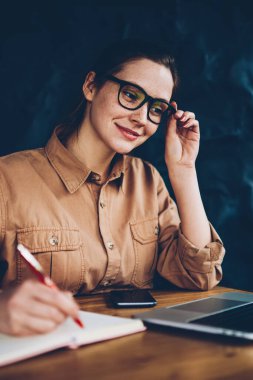 Kablosuz internet erişimi ile modern netbook üzerinde ilginç webinar online izlemek ve coworking verimli eğitim kursları Not defterinizdeki notlar aşağı yazma başarılı hipster öğrenci